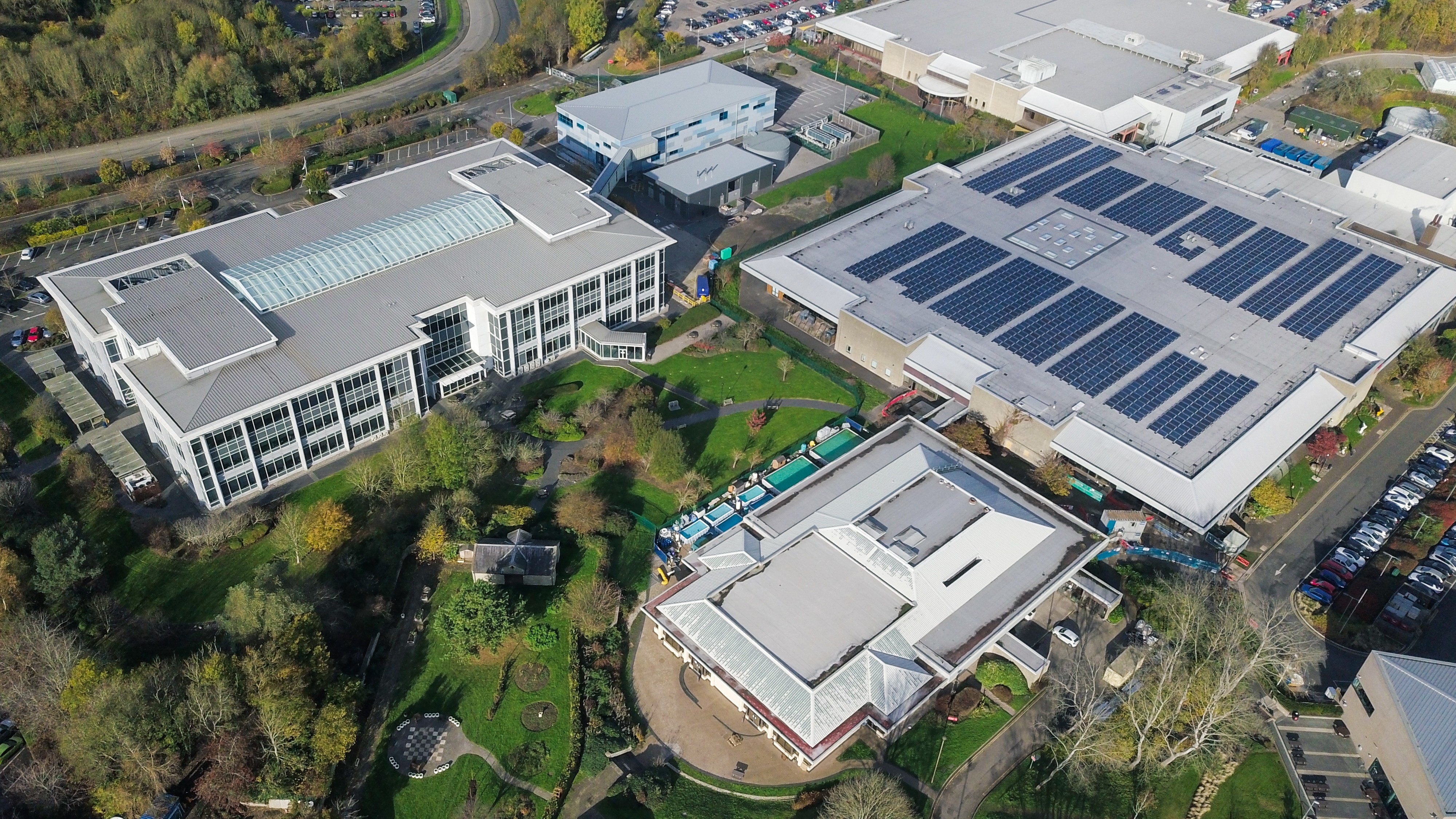 Aerial view of a commercial building with a large photovoltaic system on the hall roof